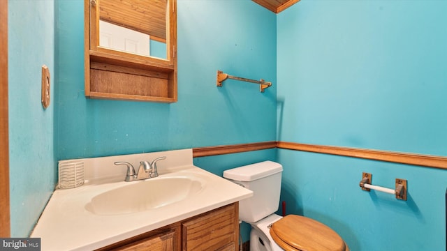 bathroom featuring toilet and vanity