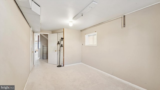 basement with light colored carpet and baseboards