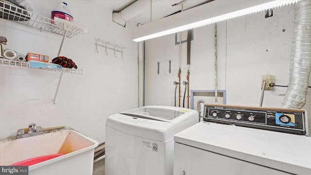 laundry area with washer and dryer, laundry area, and a sink