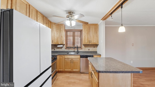 kitchen with dark countertops, light wood-type flooring, stainless steel appliances, a ceiling fan, and a sink