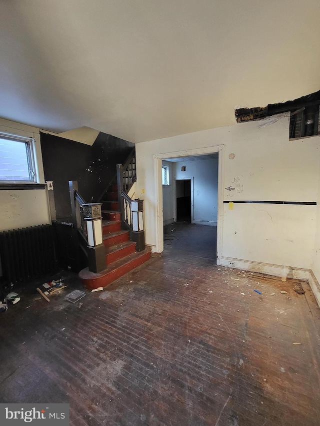 interior space featuring dark hardwood / wood-style flooring and radiator heating unit