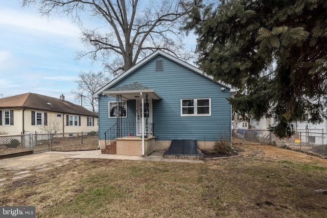 bungalow-style home with a front yard