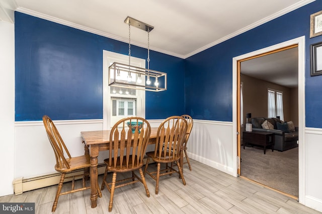 dining space featuring crown molding, an inviting chandelier, baseboard heating, and hardwood / wood-style floors