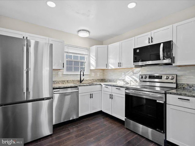 kitchen featuring light stone counters, appliances with stainless steel finishes, sink, and white cabinets