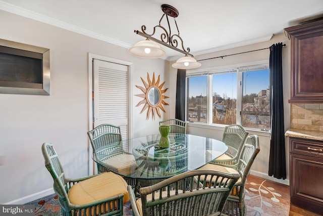 dining space featuring crown molding