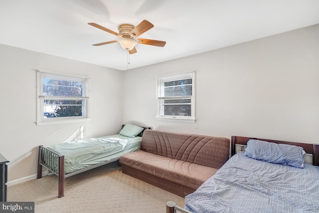 bedroom with ceiling fan, carpet, and multiple windows