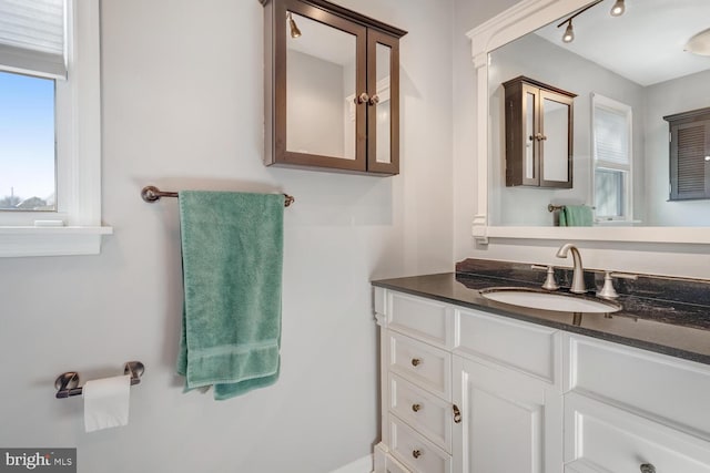 bathroom with vanity and rail lighting