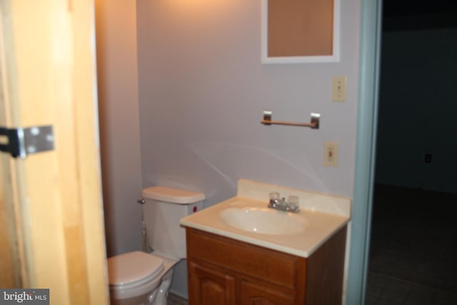 bathroom featuring vanity and toilet