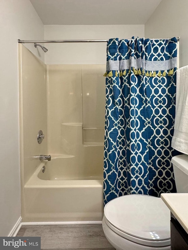 full bathroom featuring shower / bath combination with curtain, vanity, and toilet