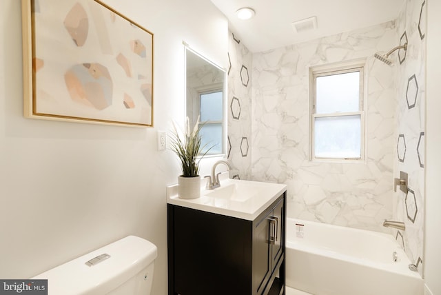 full bathroom with tiled shower / bath combo, vanity, and toilet