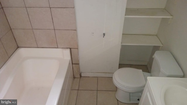 bathroom featuring vanity, toilet, a bathing tub, and tile patterned flooring