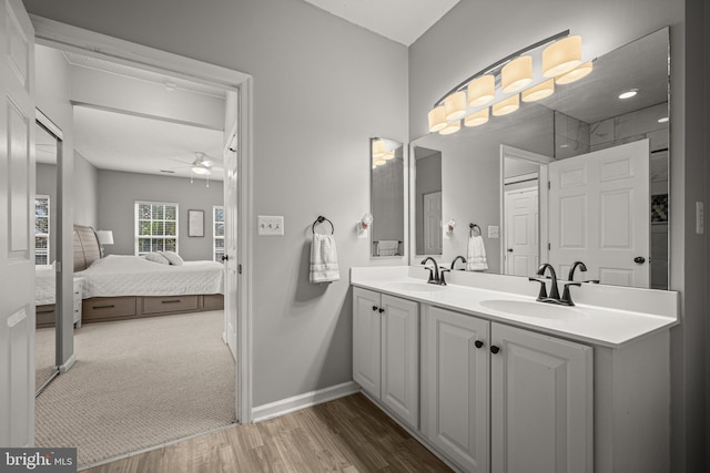 bathroom featuring hardwood / wood-style flooring, vanity, and ceiling fan