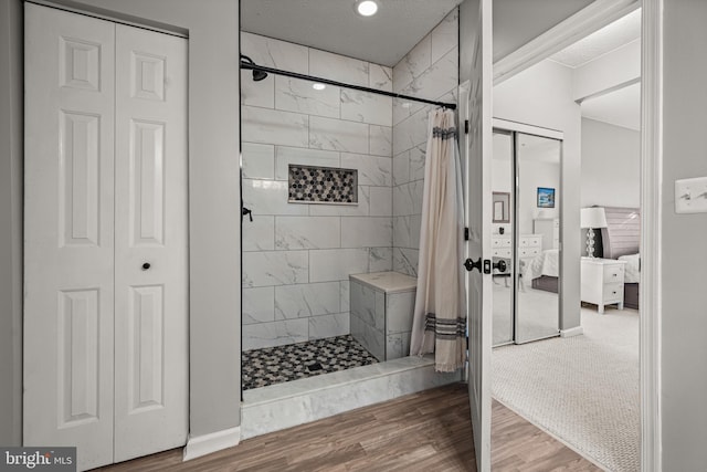 bathroom with hardwood / wood-style floors and curtained shower