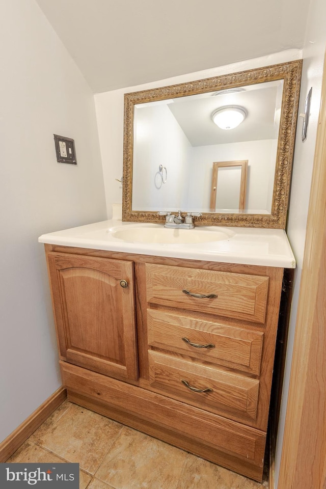 bathroom featuring vanity and vaulted ceiling