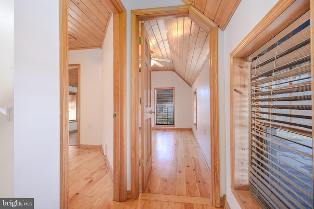 corridor featuring wood ceiling, vaulted ceiling, and light hardwood / wood-style flooring