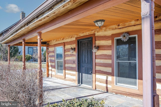 view of exterior entry featuring a porch