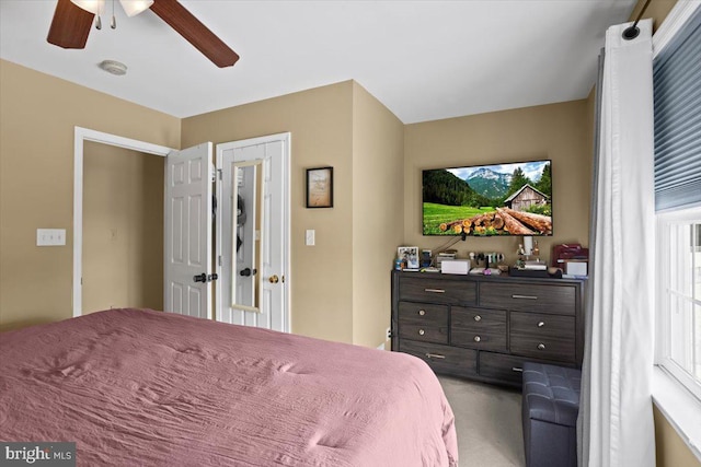 bedroom with multiple windows and ceiling fan