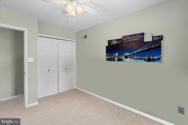 carpeted bedroom with a closet and ceiling fan