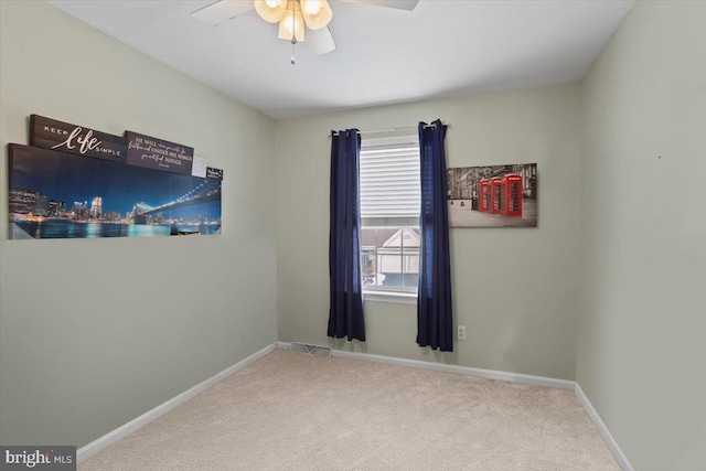 spare room featuring carpet floors and ceiling fan