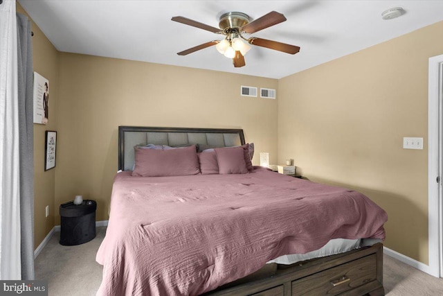 bedroom featuring light carpet and ceiling fan