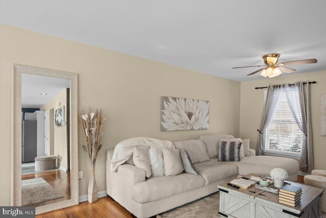 living room with hardwood / wood-style flooring and ceiling fan