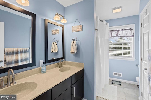 bathroom featuring vanity, toilet, and tile patterned flooring