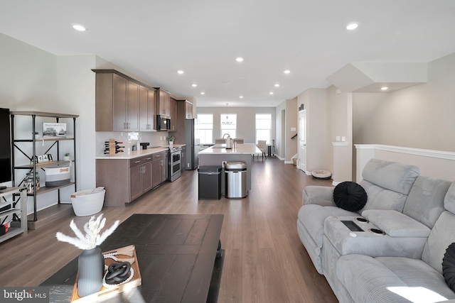 living room with sink and hardwood / wood-style floors