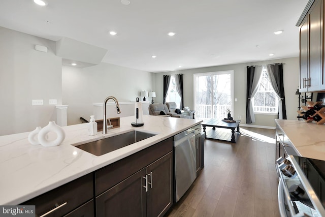 kitchen featuring dark brown cabinetry, sink, light stone counters, dark hardwood / wood-style floors, and dishwasher