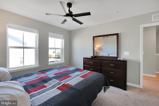 bedroom featuring light colored carpet and ceiling fan