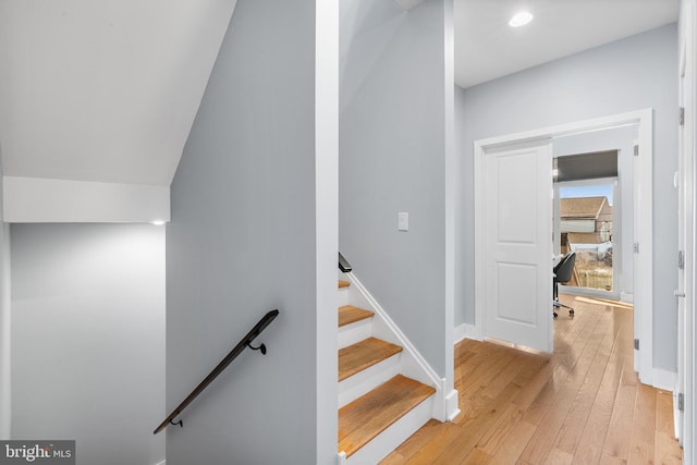 stairway with hardwood / wood-style flooring