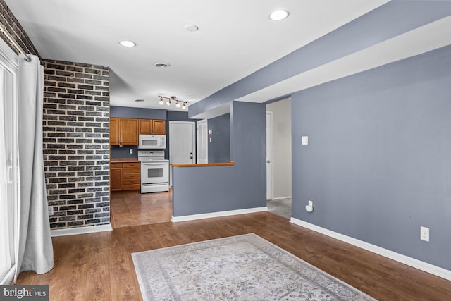 kitchen with white appliances and dark hardwood / wood-style floors