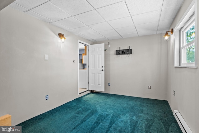 spare room featuring a baseboard radiator and carpet