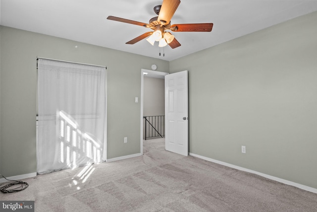 interior space featuring light colored carpet and ceiling fan