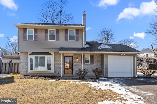 front of property featuring a garage and a front yard