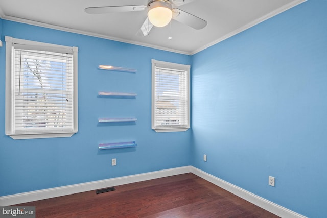 empty room featuring ceiling fan, ornamental molding, and wood-type flooring