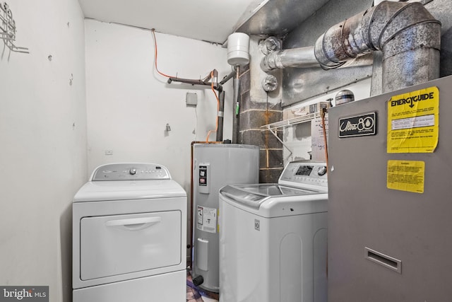 laundry room with washer and clothes dryer and electric water heater