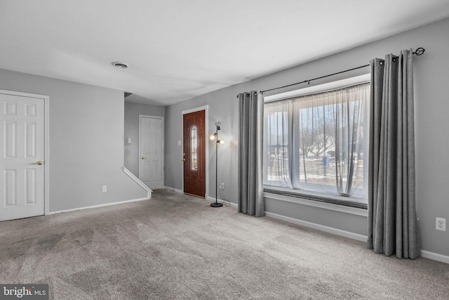 carpeted spare room with a healthy amount of sunlight