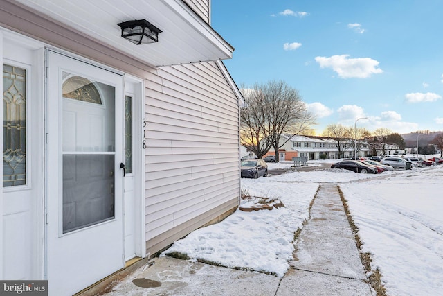 view of snow covered property entrance