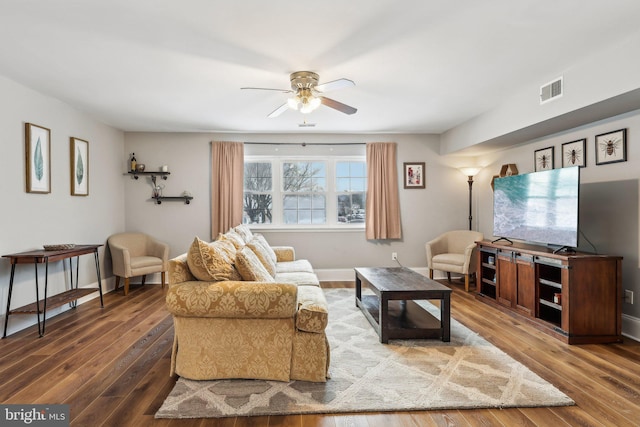 living room featuring dark hardwood / wood-style floors and ceiling fan