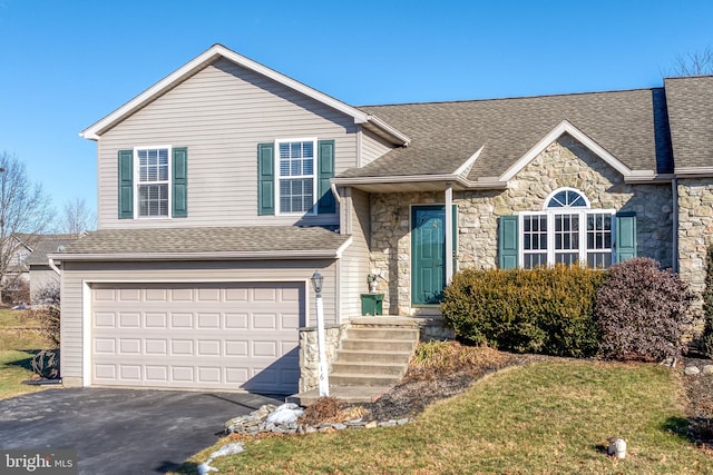 split level home featuring a garage and a front yard