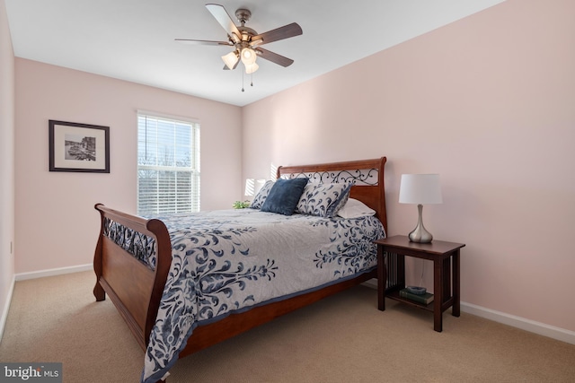 bedroom with ceiling fan and light colored carpet