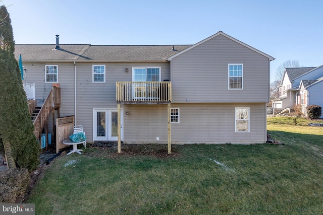 rear view of house featuring a balcony and a lawn