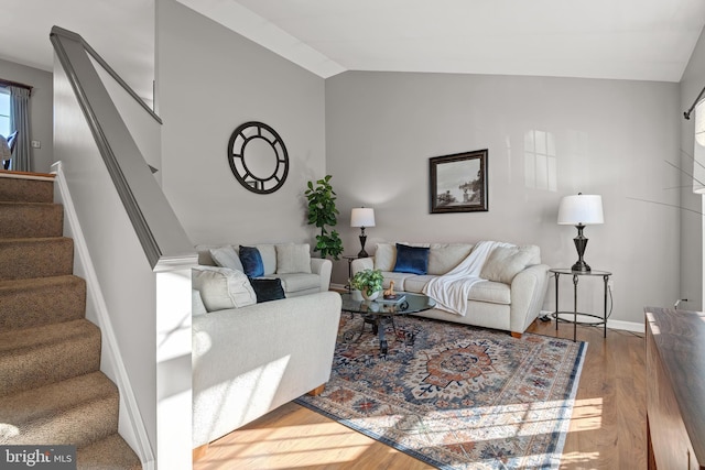 living room featuring hardwood / wood-style flooring and vaulted ceiling