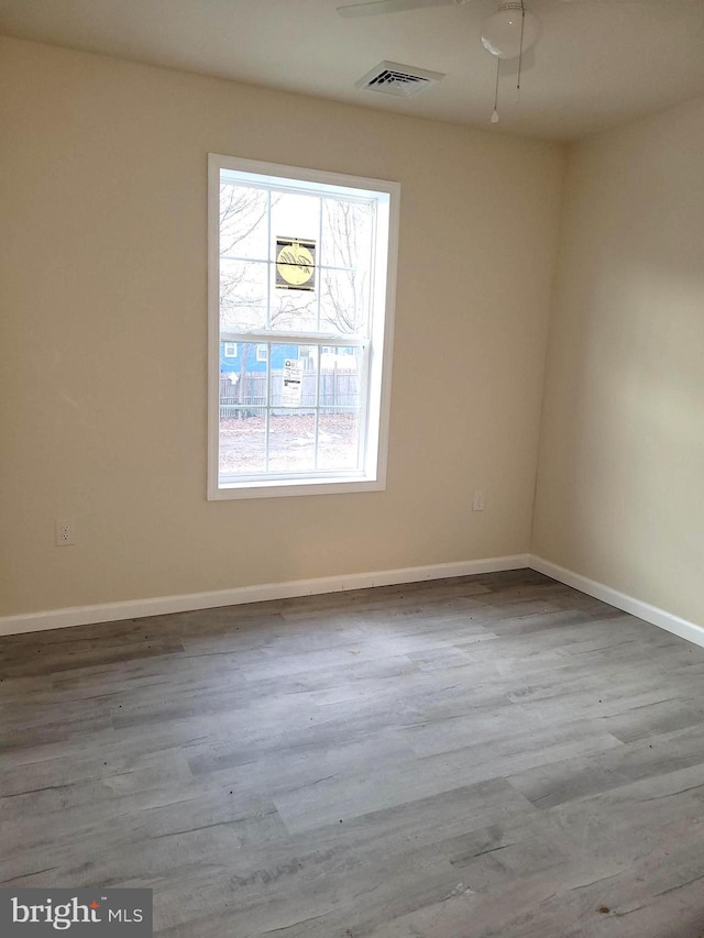 unfurnished room featuring hardwood / wood-style flooring