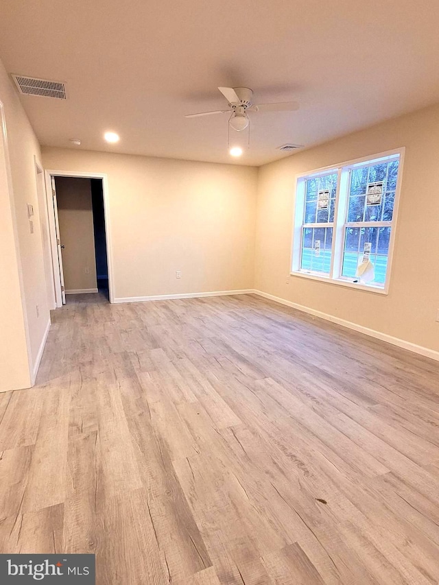 spare room with ceiling fan and light hardwood / wood-style flooring