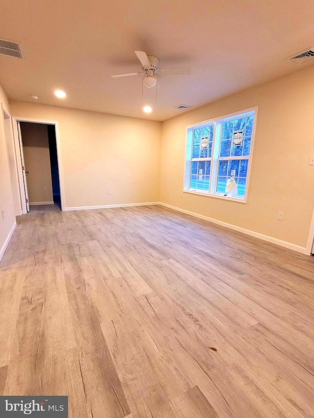 spare room with ceiling fan and light hardwood / wood-style flooring