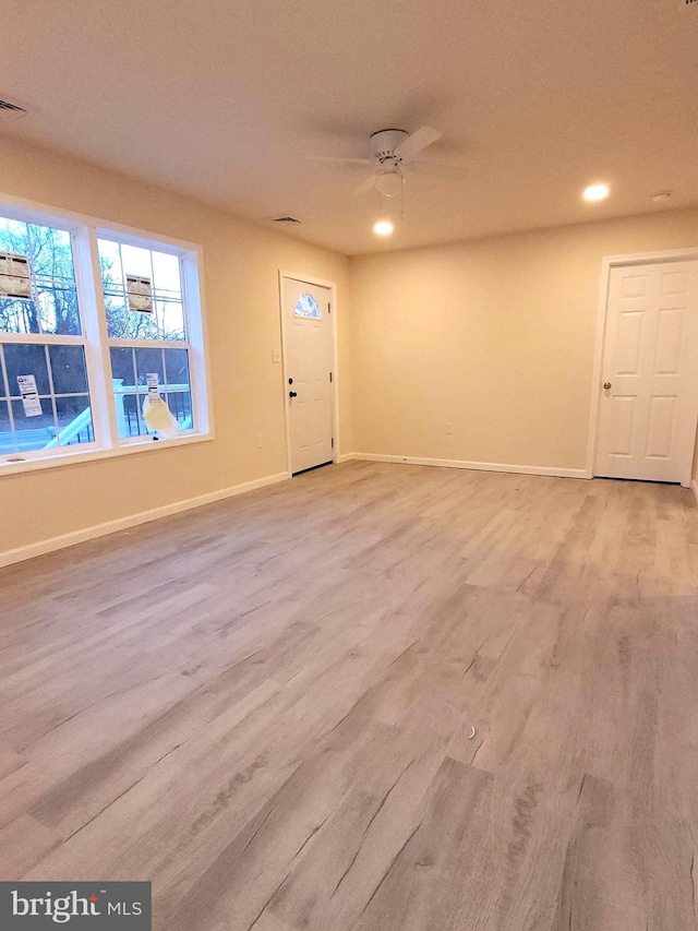 foyer with ceiling fan and light hardwood / wood-style floors