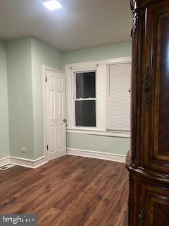 spare room featuring wood-type flooring