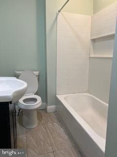 bathroom with bathing tub / shower combination and toilet