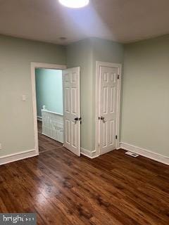 empty room featuring dark hardwood / wood-style flooring